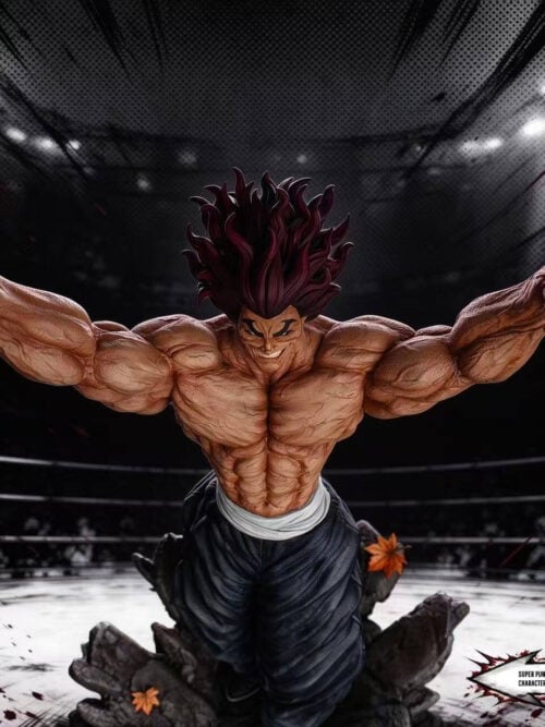 High-angle front view of the SuperPunch Studio Yujiro Hanma statue with outstretched arms and splayed fingers against an illustrated fighting ring backdrop.