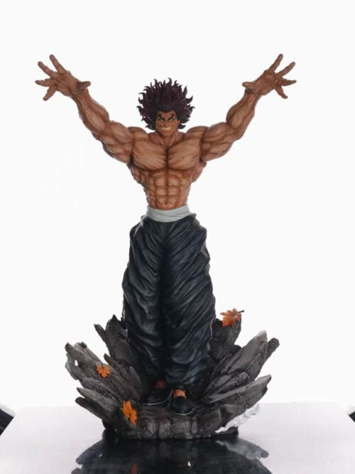 Full front view of the SuperPunch Studio Yujiro Hanma statue standing on a reflective table in front of a studio softbox light.