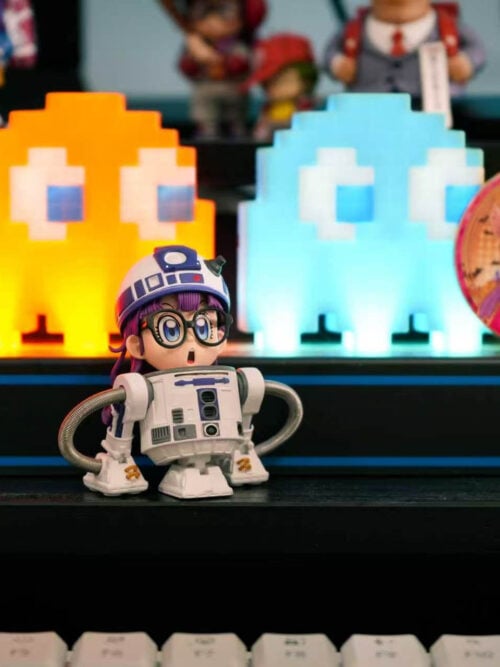 TOR Studio Arale Series Vol. 28 WCF-scale figure on a black desk shelf in front of lit pixel ghost lights and an illustrated Arale badge, angled slightly to the right.