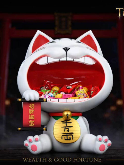 Front view of Stone Custom Studio Turbo Granny maneki-neko entryway display piece holding assorted wrapped candies inside the open mouth against a shrine background.