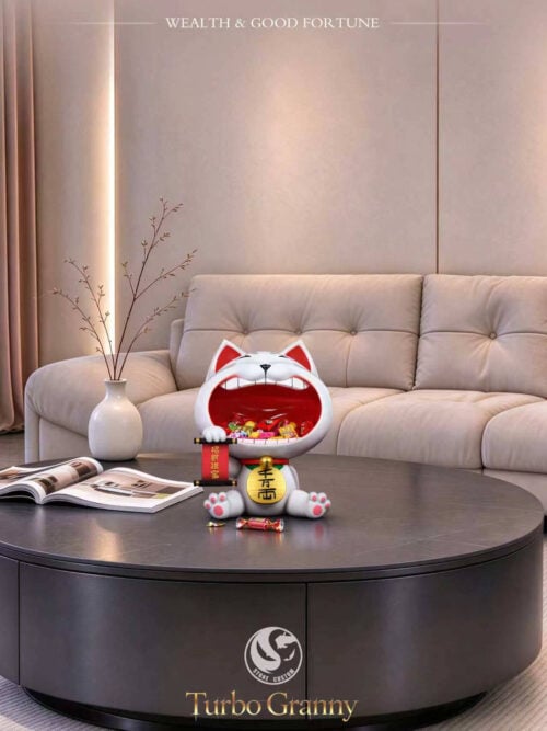 Stone Custom Studio Turbo Granny maneki-neko entryway display piece holding wrapped candies on a round coffee table in front of a sofa.