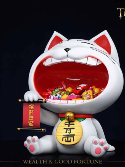 Angled view of Stone Custom Studio Turbo Granny maneki-neko entryway display piece holding wrapped candies inside the open mouth on a black background.