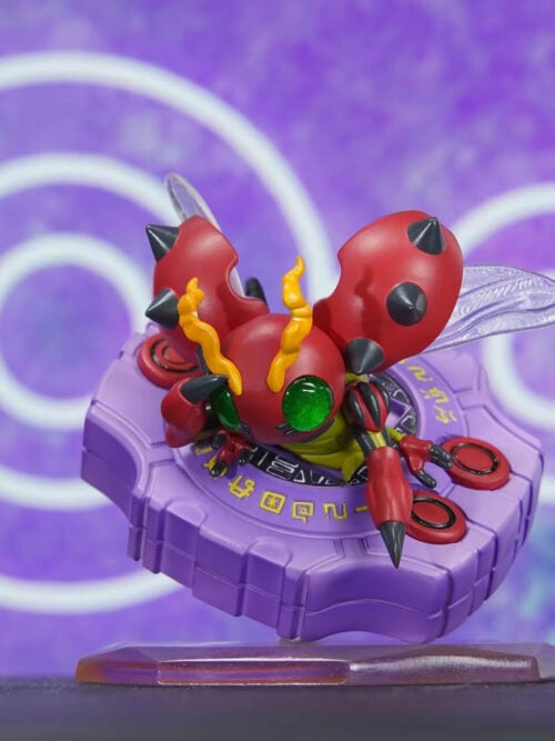 High-angle front view of the VG Studio Cute Series Tentomon figure emerging from a purple Digivice with yellow screen ring markings and red buttons on a translucent hexagonal base.