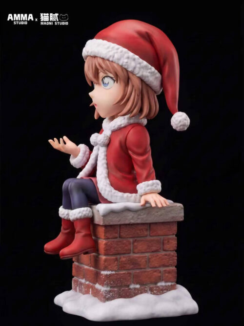 Side view of Ai Haibara seated on a snowy brick chimney, showing her Santa hat, raised palm, red coat and dangling boots.