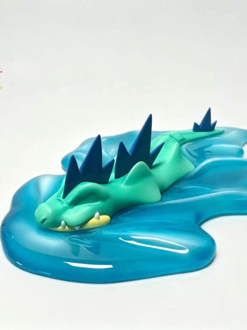 Green Feraligatr with dark blue crests in a low swimming pose on a blue water-wave base.