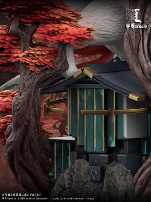 Close-up of teal architectural panels, a dark roof and gold-colored trim between textured tree trunks and red foliage.