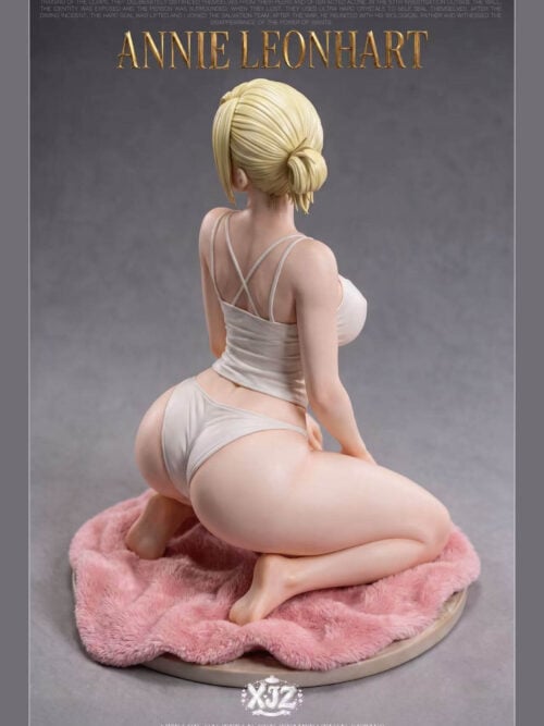 Back view of Annie Leonhart showing her blonde bun and crossed camisole straps, with a pink rug and circular base.