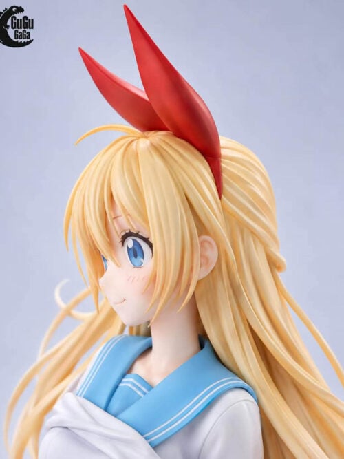 Side portrait of Chitoge Kirisaki showing her red ribbon, layered blonde hair, blue eye and pale blue sailor collar.