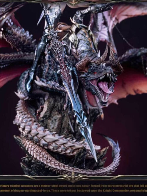 Close-up of the dragon's horned head, open mouth and coiled tail beside an ornate weapon blade on Hildr's statue.