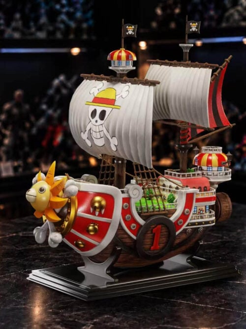 Original Color Thousand Sunny showing both white sails, the green deck, tiered stern cabins and number 1 hull panel on a rectangular stand.
