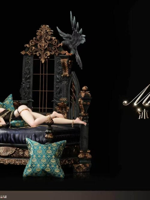 Angled view of Aeolian reclining on the Collector's Version bed, with turquoise cushions and an ornamental backdrop beneath a bird.