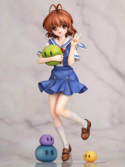 Front view of Nagisa Furukawa holding a green mascot and making a peace sign, with blue, purple and yellow mascots beside her feet.