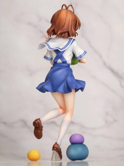Rear view of Nagisa Furukawa showing crossed blue back straps, a flared skirt, white knee-high socks and brown shoes.