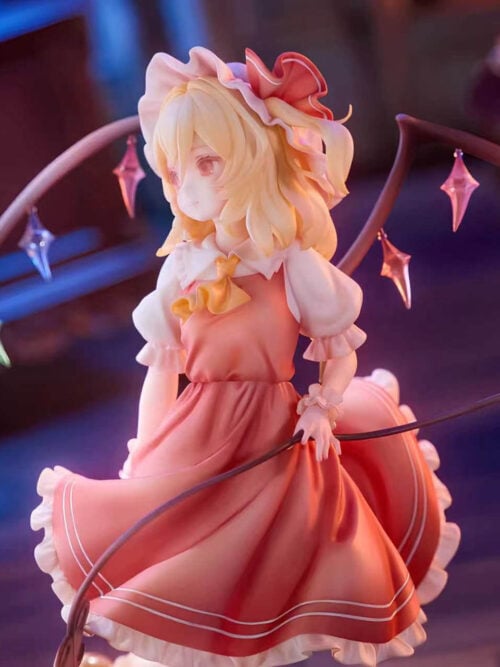 Flandre Scarlet in a red dress with white frills, framed by colorful wing ornaments and holding a long curved weapon across her skirt.