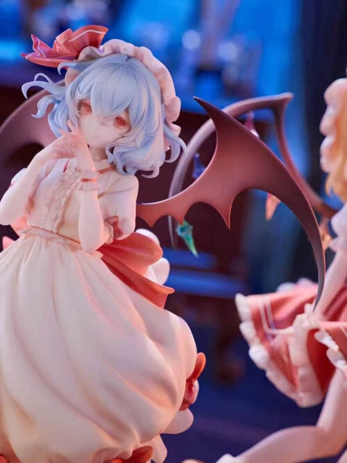 Remilia Scarlet in focus with hands near her face and bat-like wings spread, with Flandre Scarlet softly blurred behind her.