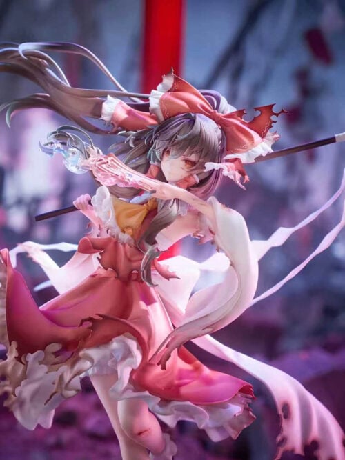Three-quarter detail of Reimu Hakurei holding a pink talisman, with a dark wand, trailing white paper streamers and ragged sleeves and skirt.