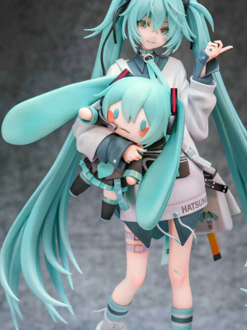 Front detail of Hatsune Miku cradling a doll with broad turquoise twin-tails, a headset, dark sleeves and a pleated skirt.