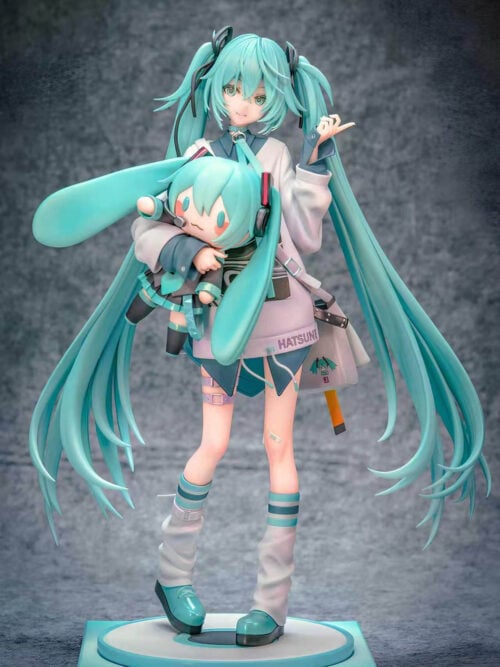 Full-length front view of Hatsune Miku holding a Miku doll, with a shoulder bag and turquoise shoes above a circular platform on a square base.