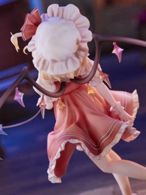 Rear view of Flandre Scarlet showing curved wings with multicolored crystal-shaped ornaments, a ruffled bonnet and a red dress.