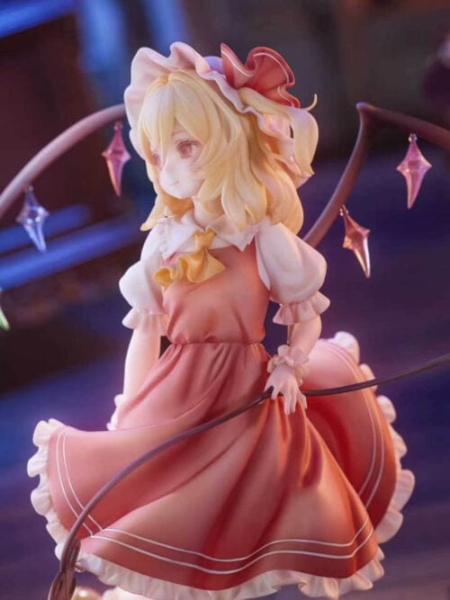 Flandre Scarlet in a red dress and yellow neck bow, framed by crystal-adorned wings with a curved weapon across her skirt.