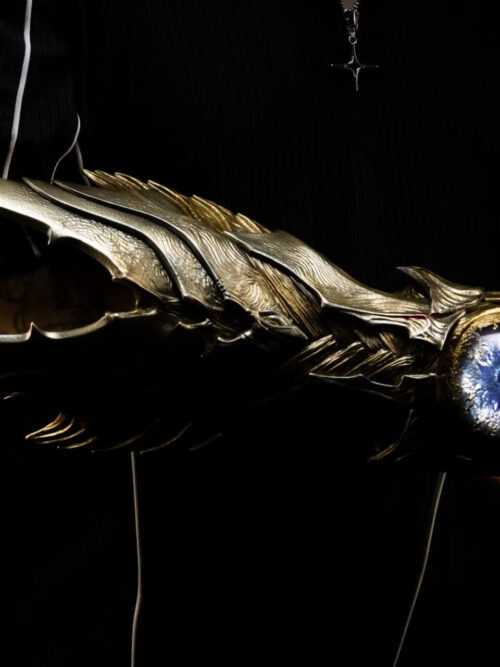 Oni Gauntlet displayed horizontally on an arm, showing sweeping pointed armor plates and the illuminated blue eye-like centerpiece.