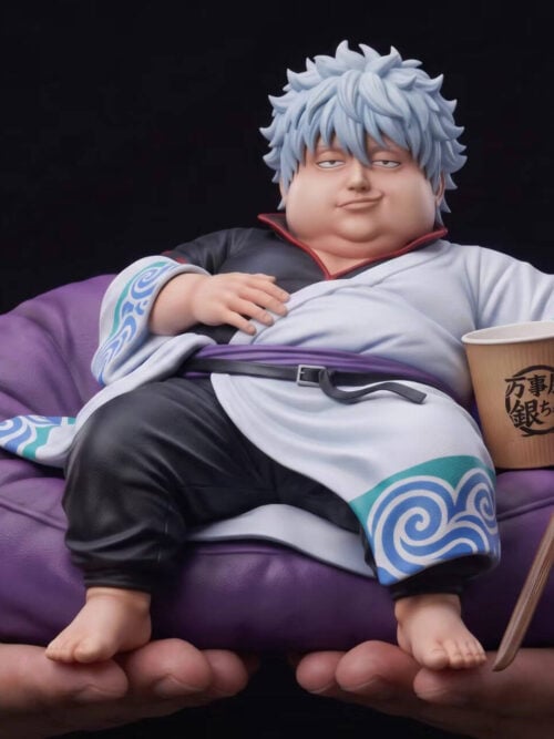 Two hands support the Gintoki Sakata figure and purple beanbag, showing his bare feet, large cup and wooden sword.