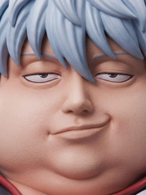 Close-up of Gintoki Sakata's rounded face, half-lidded eyes and slight smirk beneath spiky silver-blue hair.