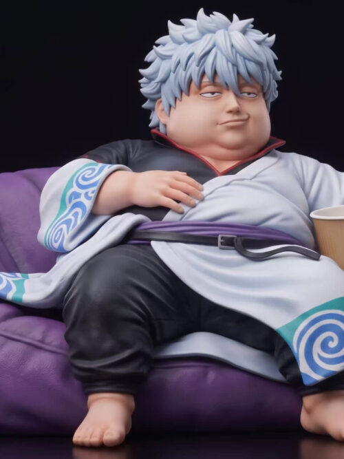 Angled full view of Gintoki Sakata reclining in a purple beanbag, with one hand on his belly, bare feet, a cup and a wooden sword.