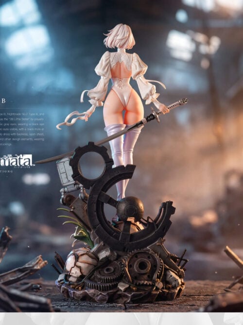 Full rear view of 2B holding a long sword and white blindfold above a tall base of broken gears, machine remains and flowers.