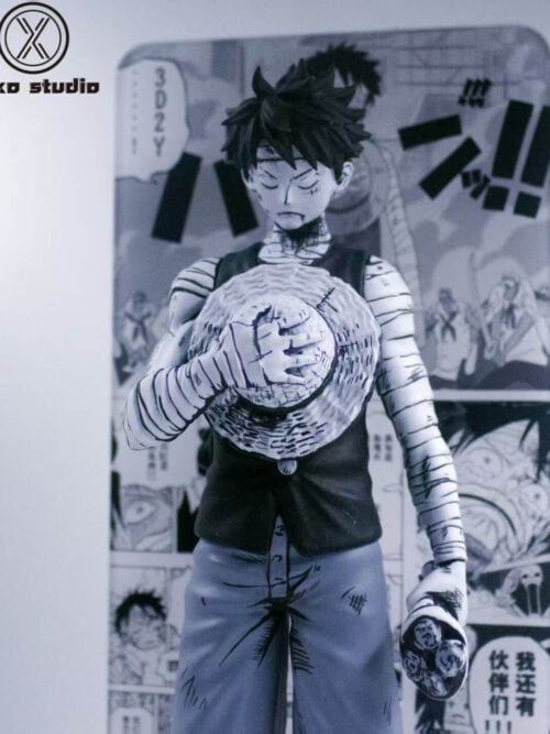 Front detail of black-and-white Luffy with closed eyes, bandaged arms, a straw hat against his chest and a lowered bouquet.