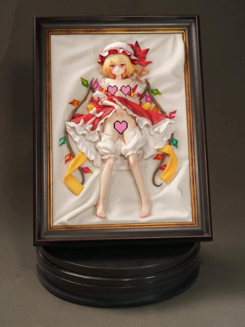 Censored front-view photo of Flandre Scarlet in a black-and-gold frame with white drapery, colorful wing ornaments and a black circular platform.