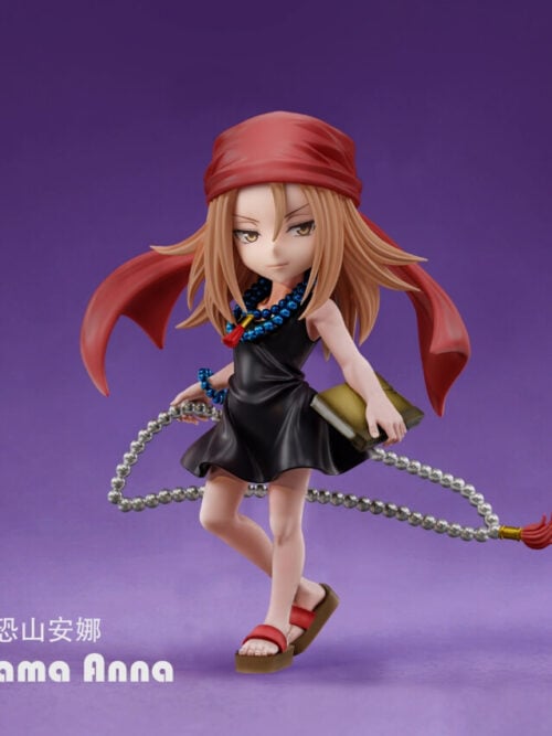 Anna Kyoyama figure in a black dress and red headscarf, holding a book beside a looping silver-colored bead strand against a purple background.