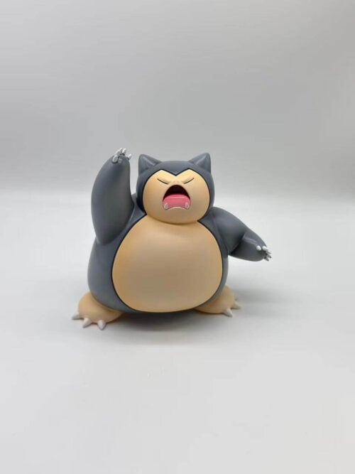 Dark gray Snorlax figure with a cream face and belly, one arm raised and the other extended outward.