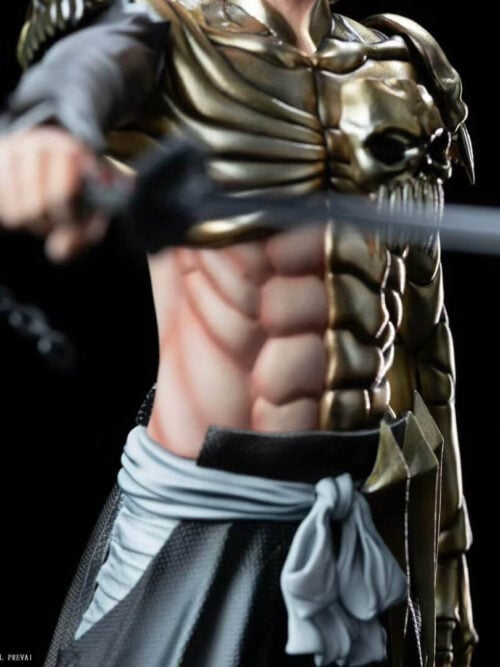 Close-up of Ichigo's gold-toned skull chest armor, rib-like plates, exposed abdomen and gray sash, with the sword across the foreground.