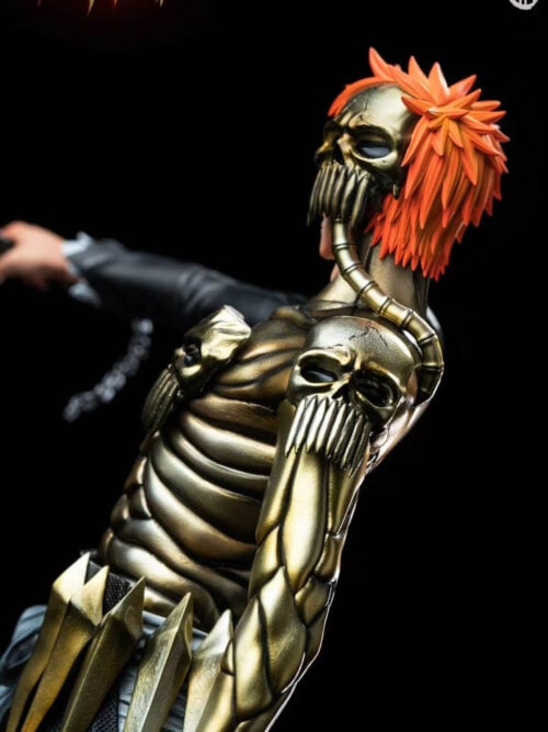 Angled close-up of Ichigo's orange hair, skull half-mask, skull shoulder armor and segmented gold-toned left arm.