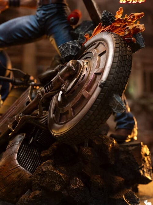 Close-up of the weathered motorcycle wheel, sculpted orange flames and suspended rubble beneath Kenshiro.