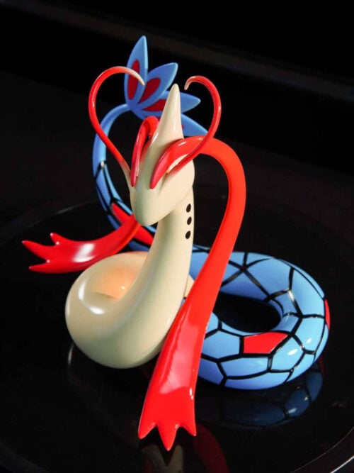 Elevated view of LD Studio's Milotic figure showing its coiled blue tail, black scale outlines, red accents and cream-colored body.