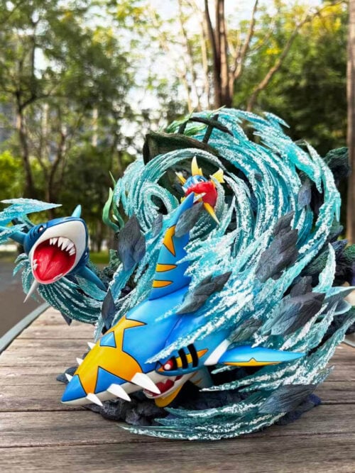 Full view of Carvanha, Sharpedo and Mega Sharpedo surrounded by curling turquoise water effects and jagged rocks.