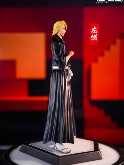 Profile view of the D·ONE Studio Izuru Kira statue from his right side, showing his blonde bangs covering the left side of his face and his hand resting on the sword hilt.