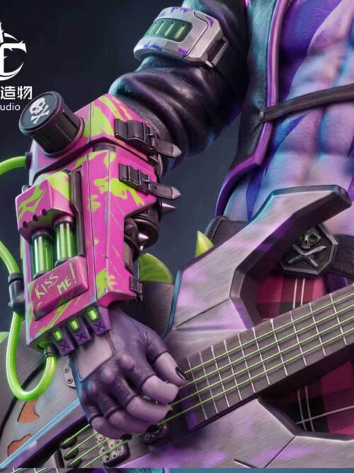 Close-up of the Hemlock statue's right gauntlet painted pink and green with KISS ME! lettering, green vials, and tubing connected to the sawblade bass guitar body.