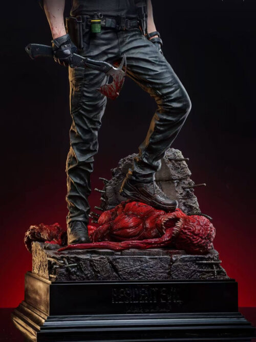 Lower body and base view showing Leon Scott Kennedy's tactical trousers and boots standing on a slain Licker over broken concrete and rebar.