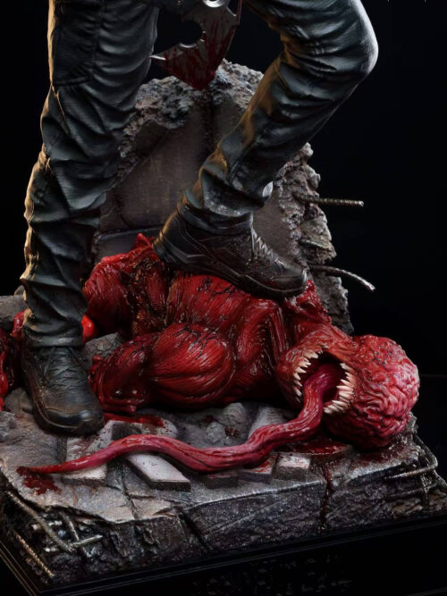 Close-up of Leon Scott Kennedy's boots planted on the muscular red body of a slain Licker with its long tongue extending across cracked concrete.