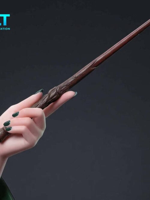 Close-up of a pale hand with dark green nails holding a brown textured wand against a dark background.