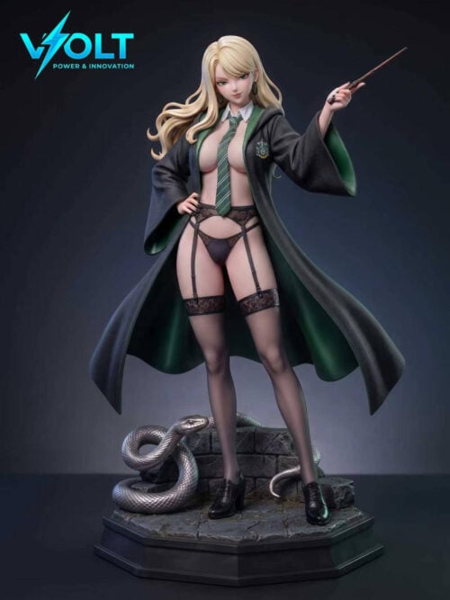 Studio view of the standing blonde figure in the lace outfit: an open dark robe with green lining over lace garments, garter straps, and stockings, with one hand raised holding a wand. A silver snake coils on the stone base.