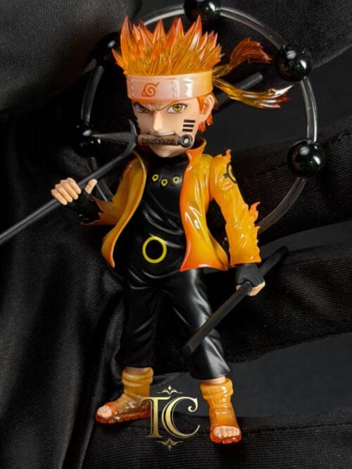 TC Studio Six Paths Naruto Uzumaki WCF Vol. 04 stylized figure held in a black-gloved hand, featuring translucent orange hair, coat, and sandals, a three-pronged kunai clenched in his teeth, dual black rods, and a clear ring of six black Truth-Seeking Balls.