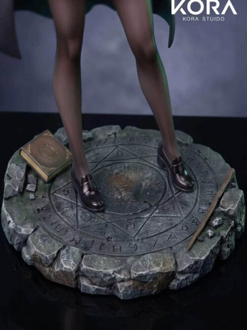 Close-up of the circular stone-textured display base etched with geometric symbols and runes, showing the figure's dark loafers, a closed gold-trimmed book, and a wand.