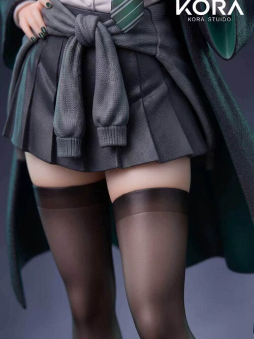 Mid-section close-up of the Malfoy Genderbent Version figure showing a grey knit sweater knotted over a dark grey pleated skirt, green-lined dark robe, and sheer dark stockings.