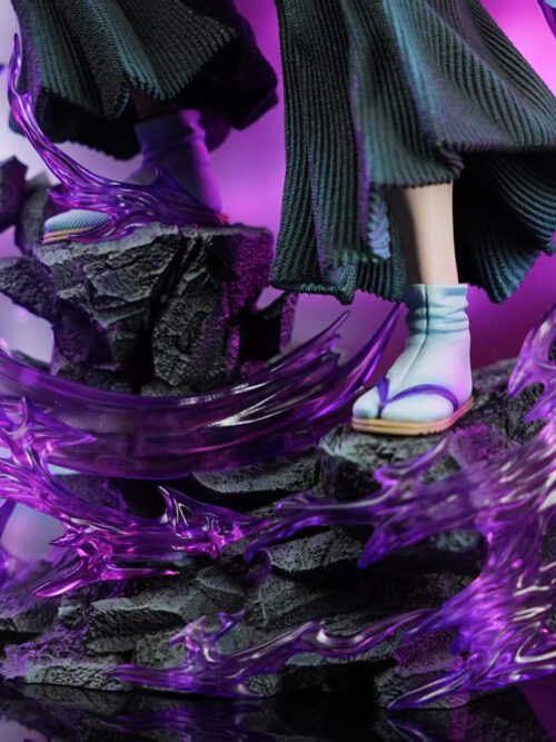 Close-up of the stepped dark rock base on the DreamHunter Studio 1/6 scale Kokushibo statue with translucent purple energy wisps, pale blue crescent blades, and white tabi socks in sandals