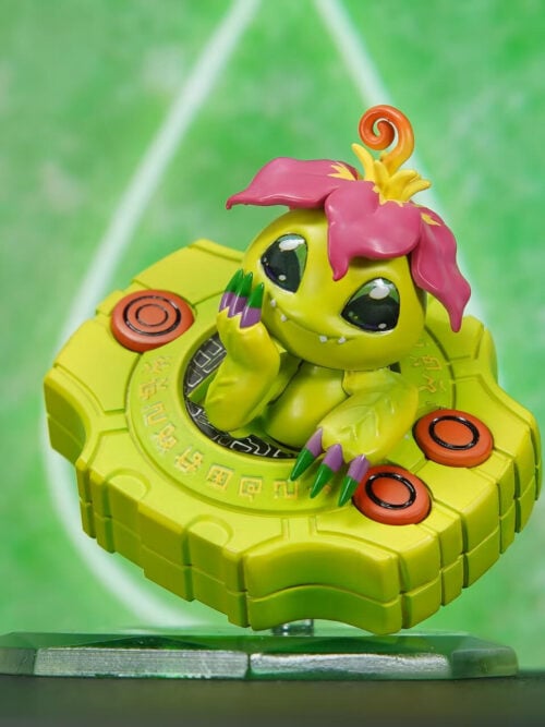 VG Studio Palmon Cute Series figure showing Palmon emerging from a tilted yellow-green Digivice with orange buttons on a translucent green base.