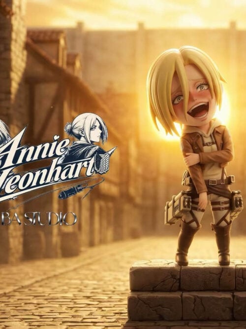BA Studio SD-scale Annie Leonhart figure from Attack on Titan laughing with her head tilted back and left hand gripping her right arm on a two-tiered cracked stone base against a sunlit street promotional backdrop
